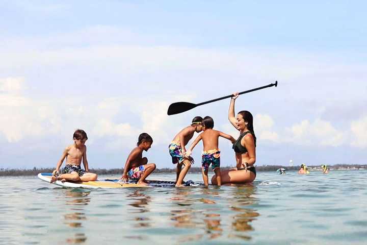 a group of people rowing a boat in the water