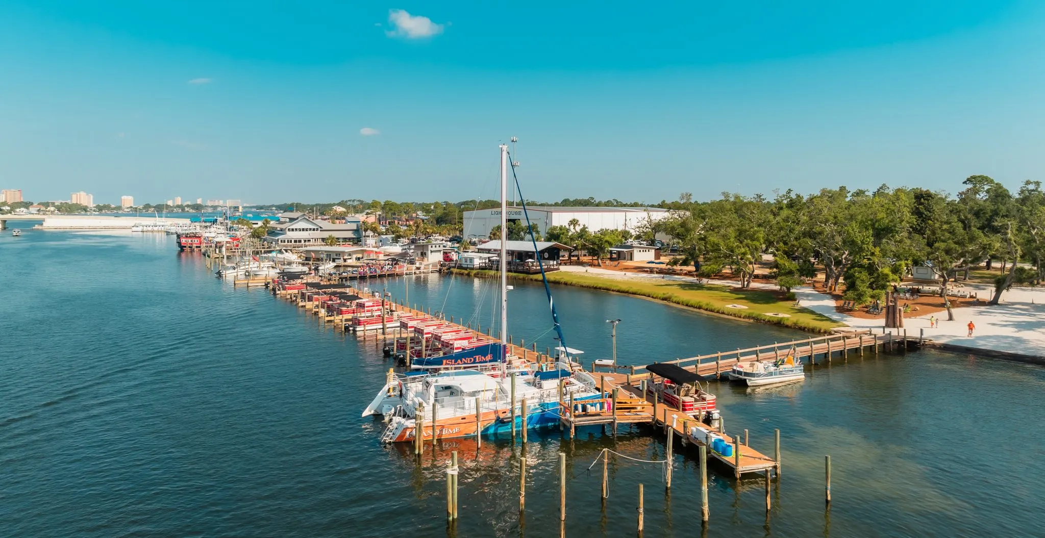 IslandTimeSailingDrone-4 a boat is docked next to a body of water
