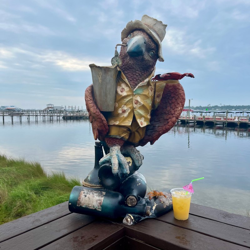 a statue in front of a body of water